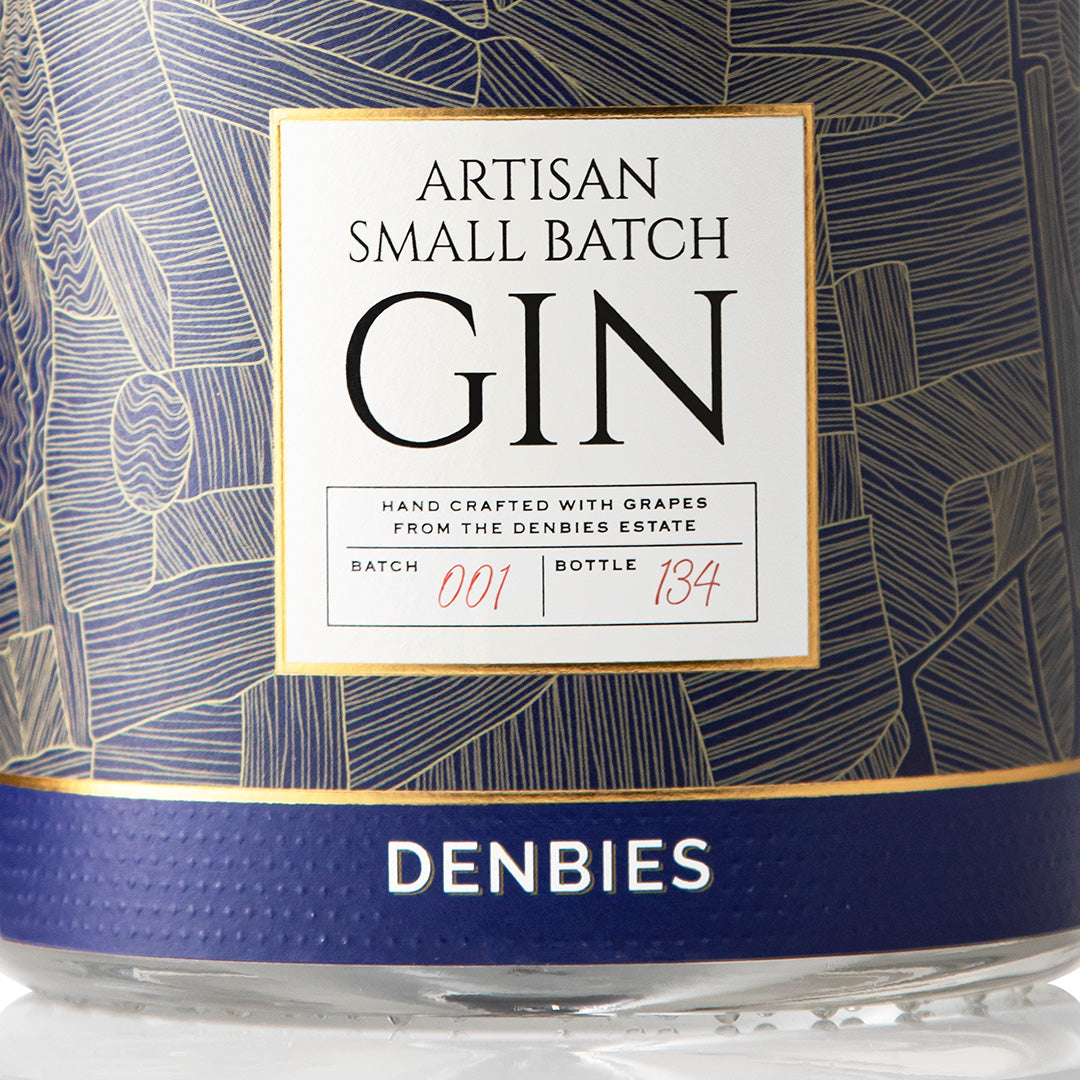 Close-up detail of the Artisan Small Batch Gin label showing the art and typography
