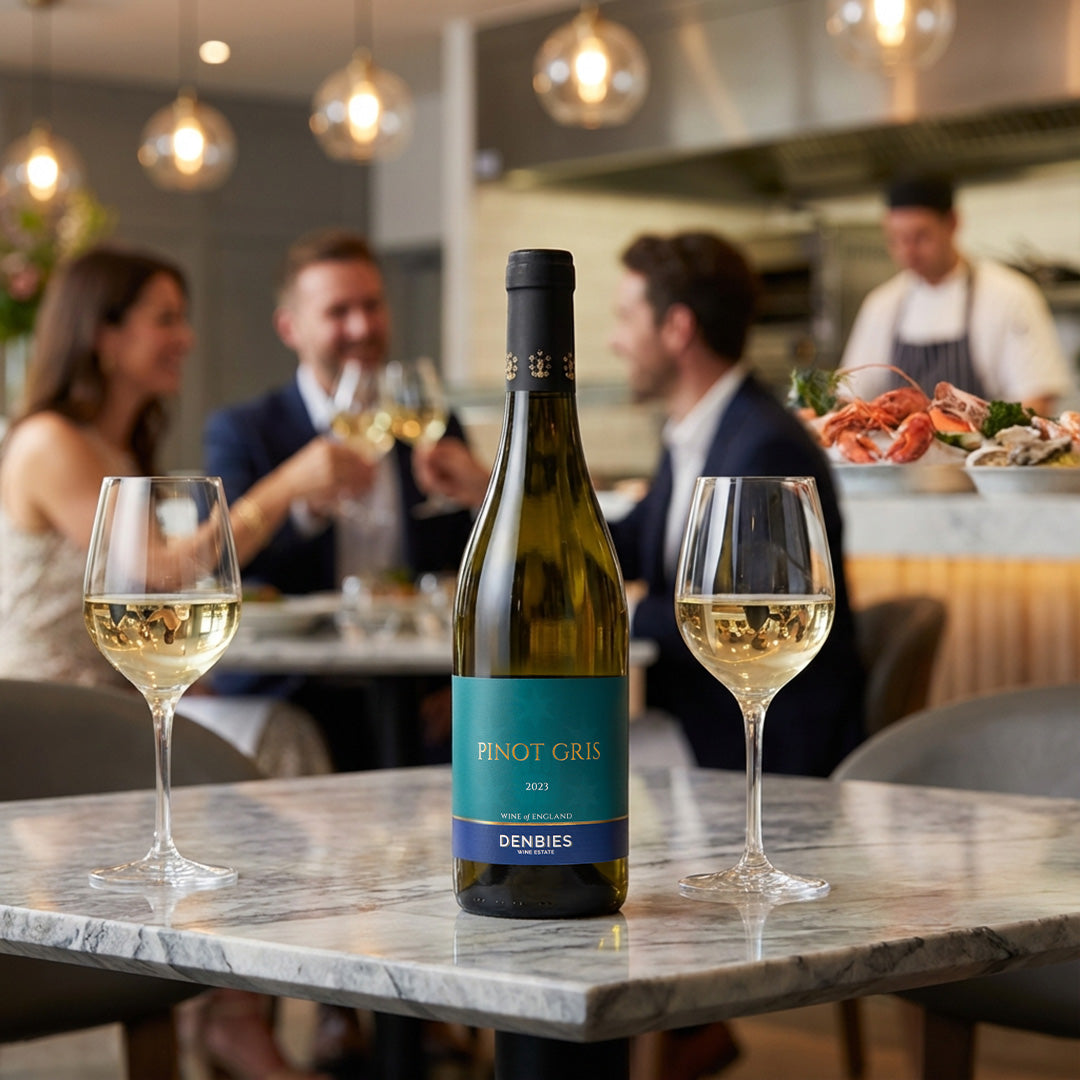 Pinot Gris 2023 wine bottle served with two glasses in a vibrant restaurants setting