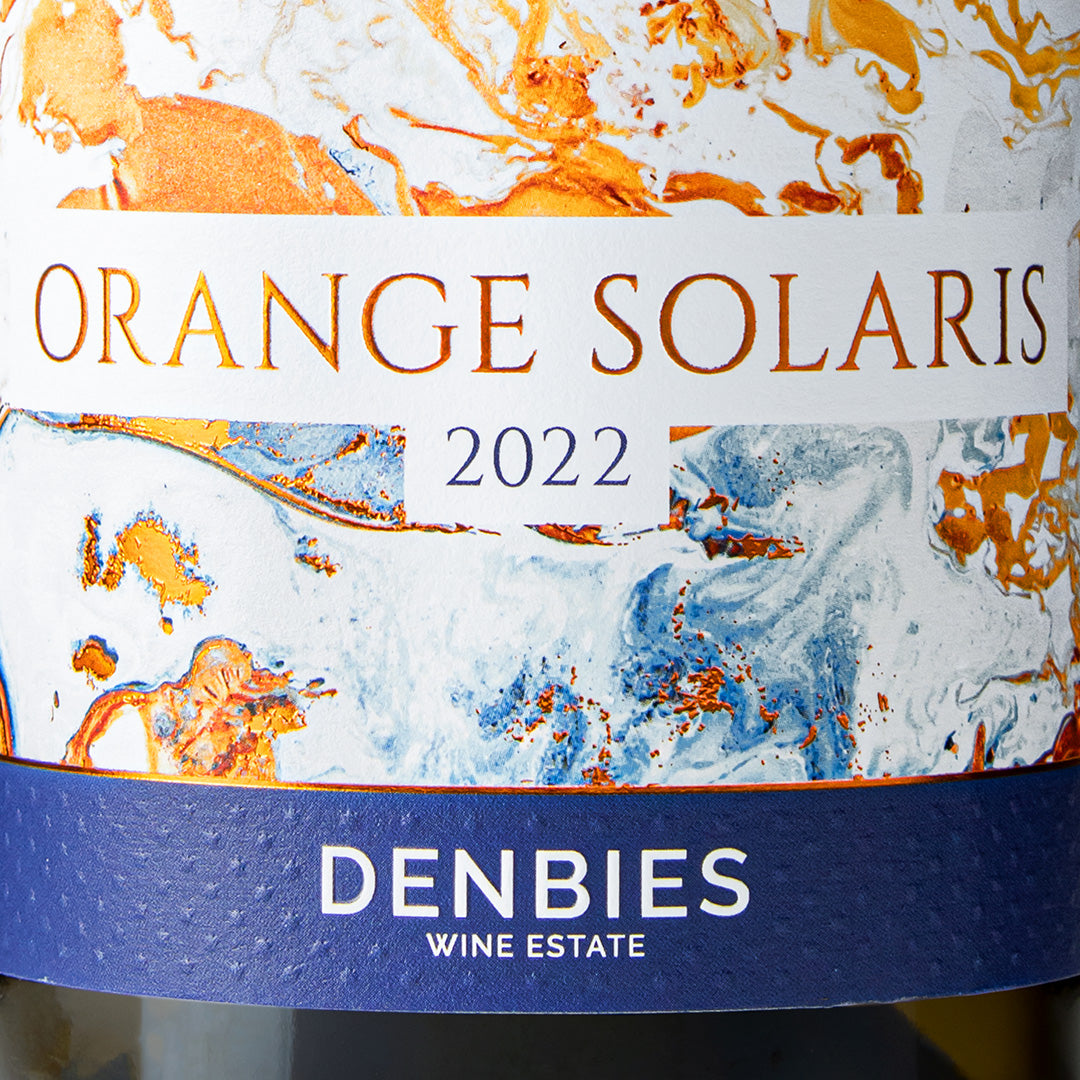 Close-up detail of the Orange Solaris 2022 wine label showing the art and typography