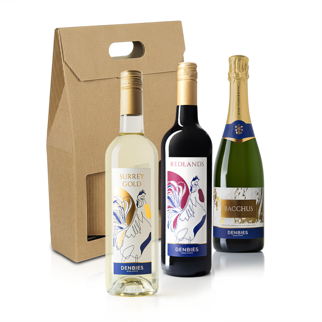 Front view of Surrey Gold, Redlands and Bacchus wine bottles by Denbies Wine Estate with a cardboard carrier on a transparent background
