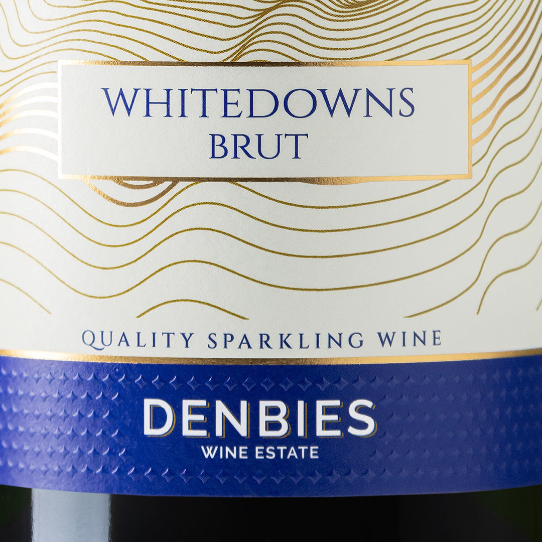 Close-up detail of the Whitedowns NV wine label showing the art and typography