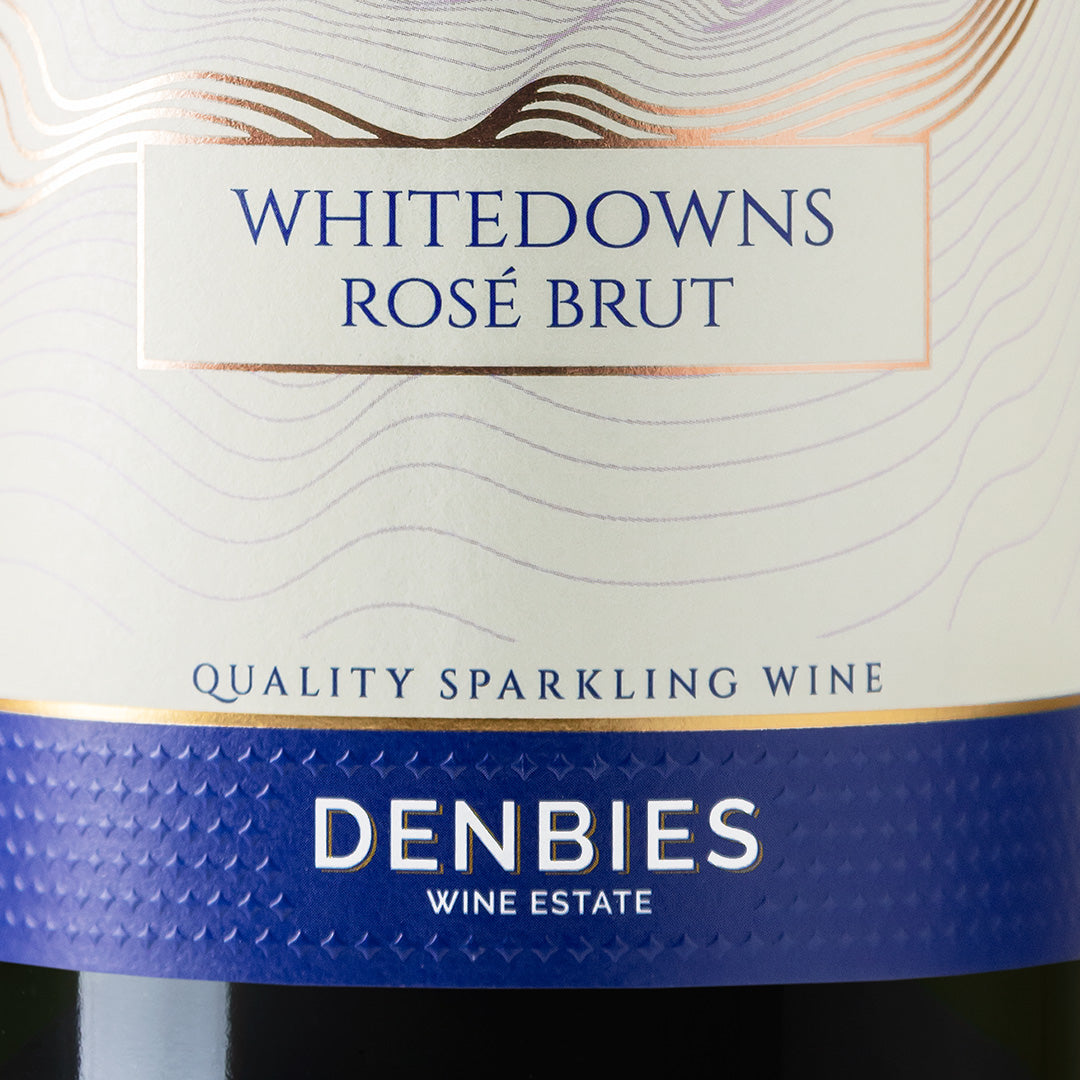 Close-up detail of the Whitedowns Rose NV wine label showing the art and typography